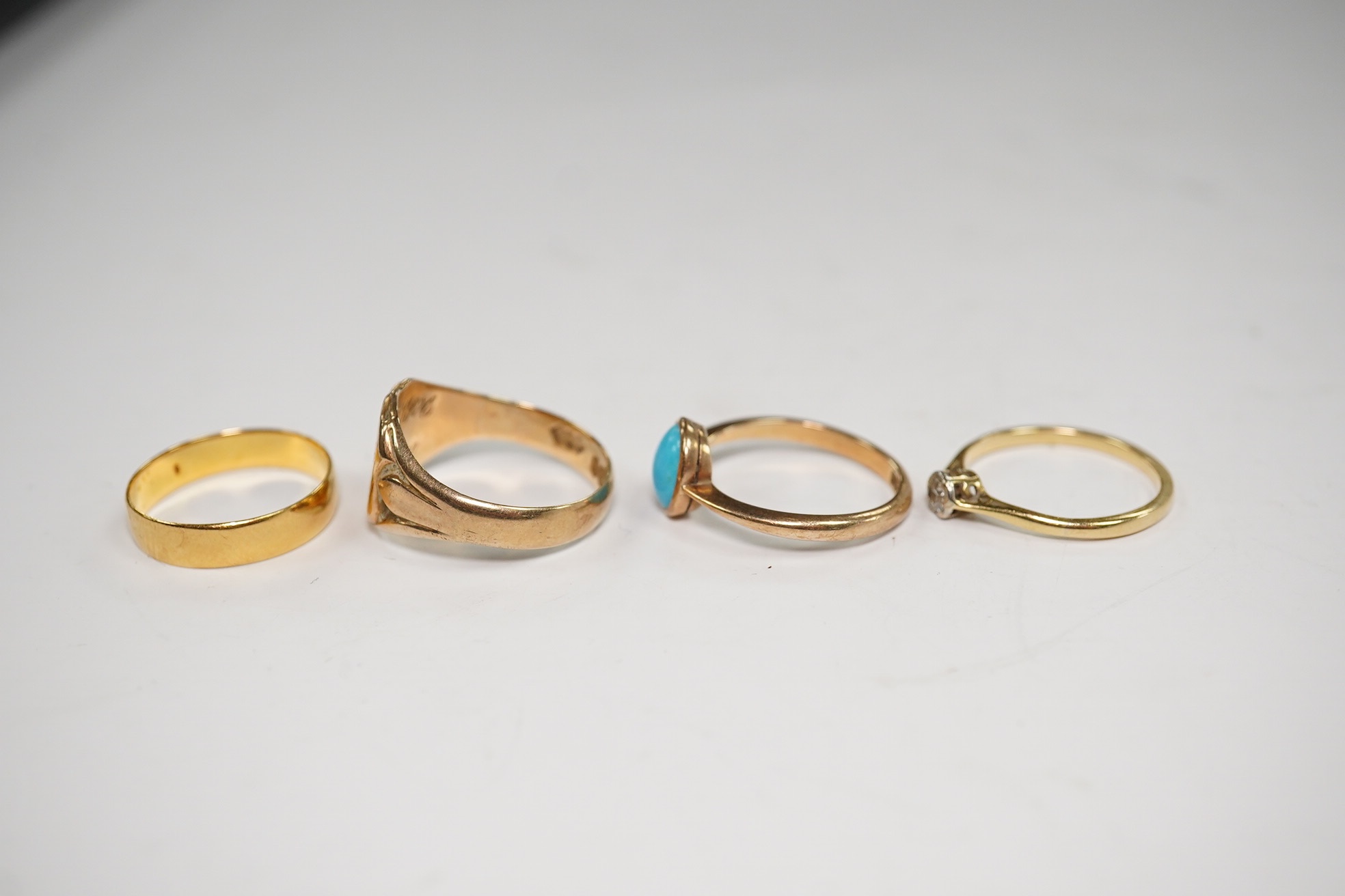 A 22ct gold wedding band, 2.6 grams, a yellow metal and solitaire diamond set ring and two 9ct gold rings including a signet ring, gross weight 9.3 grams. Condition - poor to fair